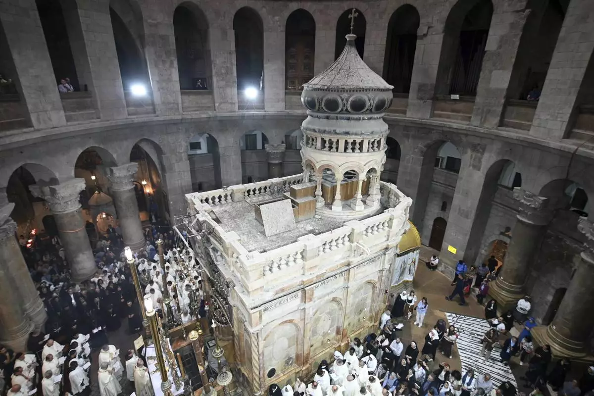 Clergy and worshippers take part in a Mass led by Latin Patriarch Pierbattista Pizzaballa, the top Catholic clergyman in the Holy Land, in remembrance of Pope Francis at the Church of the Holy Sepulcher, the site where according to tradition Jesus was crucified and buried, in the Old City of Jerusalem, Wednesday, April 23, 2025. (AP Photo/Mahmoud Illean)