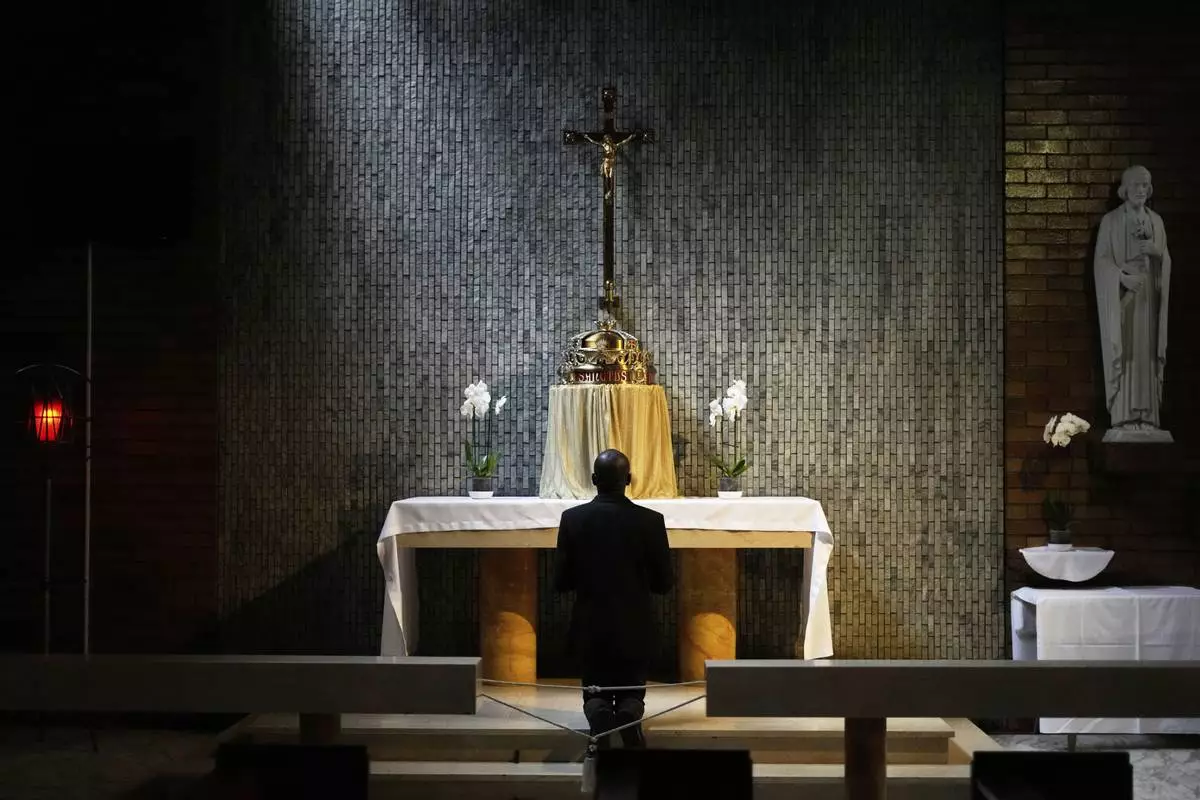 A Catholic man prays after the Pope Francis Memorial Mass, at the Cathedral of Christ the King, Johannesburg, South Africa, Wednesday, April 23, 2025. (AP Photo/Themba Hadebe)