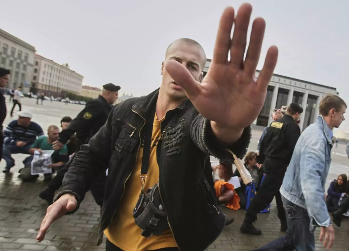 FILE - A plainclothes police officer obstructs a photographer working at an opposition rally in Minsk, Belarus, on Sept. 16, 2009.(AP Photo, File)