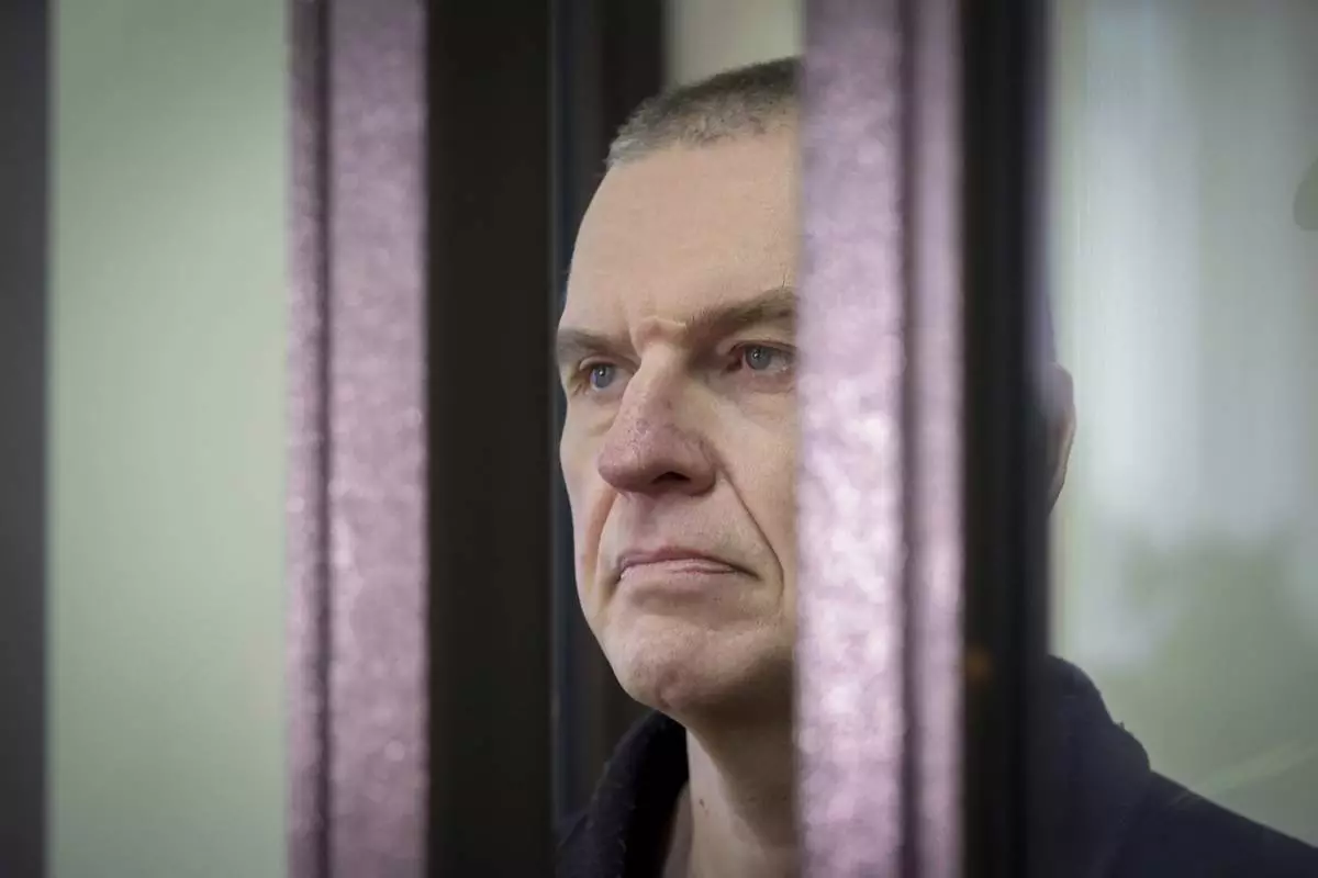 FILE - Journalist Andrzej Poczobut stands in a defendants' cage in court in Grodno, Belarus, on Jan. 16, 2023. (Leonid Shcheglov/Pool via AP, File)