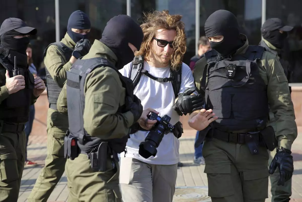 FILE - Police detain a photojournalist at an opposition rally protesting presidential election results in Minsk, Belarus, on Sept. 26, 2020. (AP Photo, File)