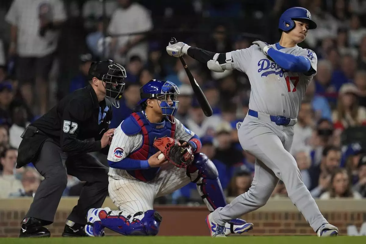 Los Angeles Dodgers designated hitter Shohei Ohtani (17) strikes out during the eighth inning of a baseball game against the Chicago Cubs, Tuesday, April 22, 2025, in Chicago. (AP Photo/Erin Hooley)