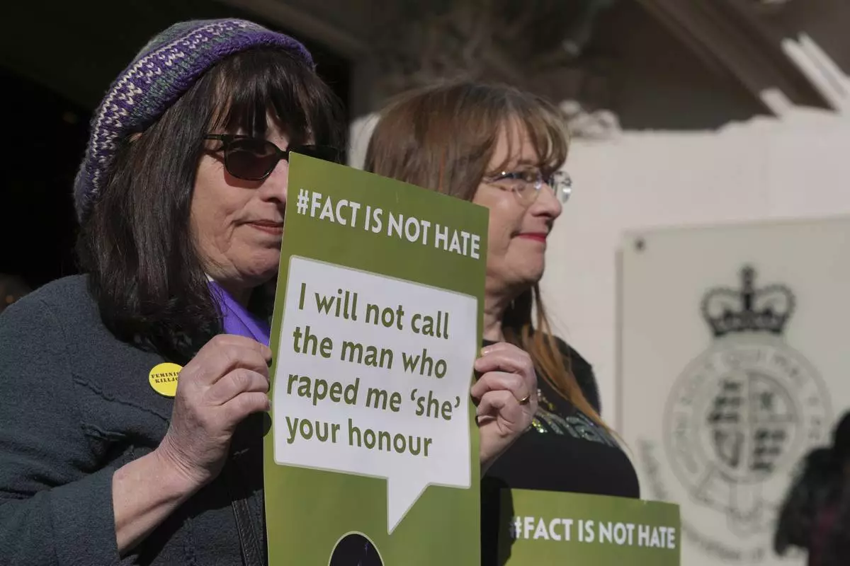 Women's rights activists hold placards outside the Supreme Court to challenge gender recognition laws, in London, Wednesday, April 16, 2025. (AP Photo/Kin Cheung)