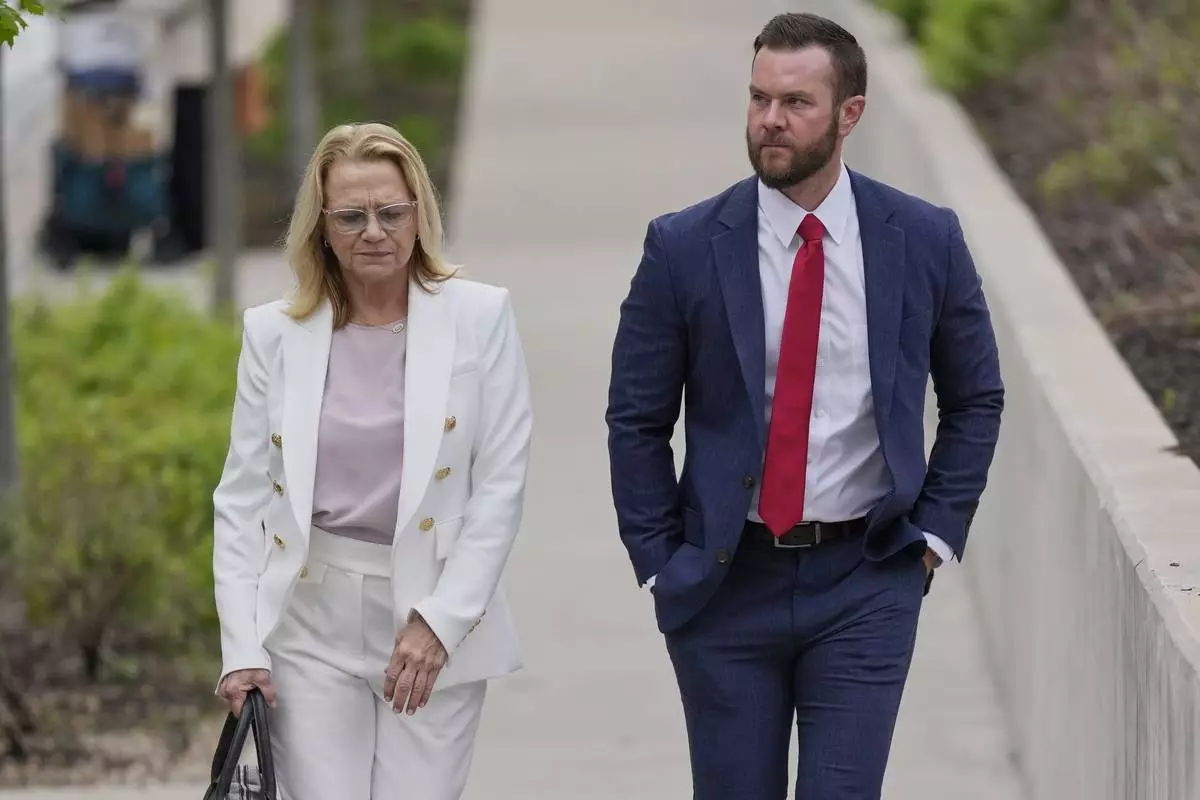 Cade Cothren, the former chief of staff to former Tennessee House Speaker Glen Casada, right, arrives at the federal courthouse with his attorney Cynthia Sherwood, right, Tuesday, April 22, 2025, in Nashville, Tenn. (AP Photo/George Walker IV)