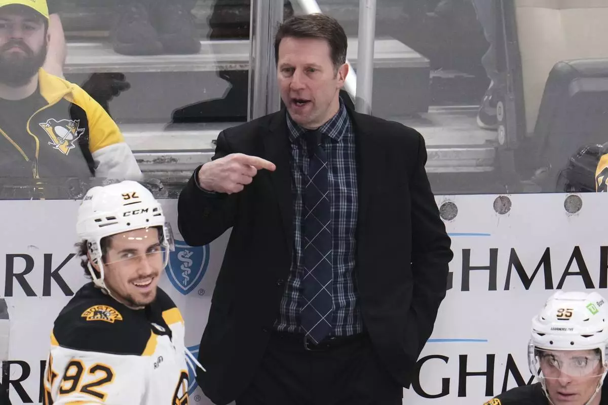 Boston Bruins interim head coach Joe Sacco gives instructions from behind his bench during the third period of an NHL hockey game against the Pittsburgh Penguins in Pittsburgh, Sunday, April 13, 2025. (AP Photo/Gene J. Puskar)