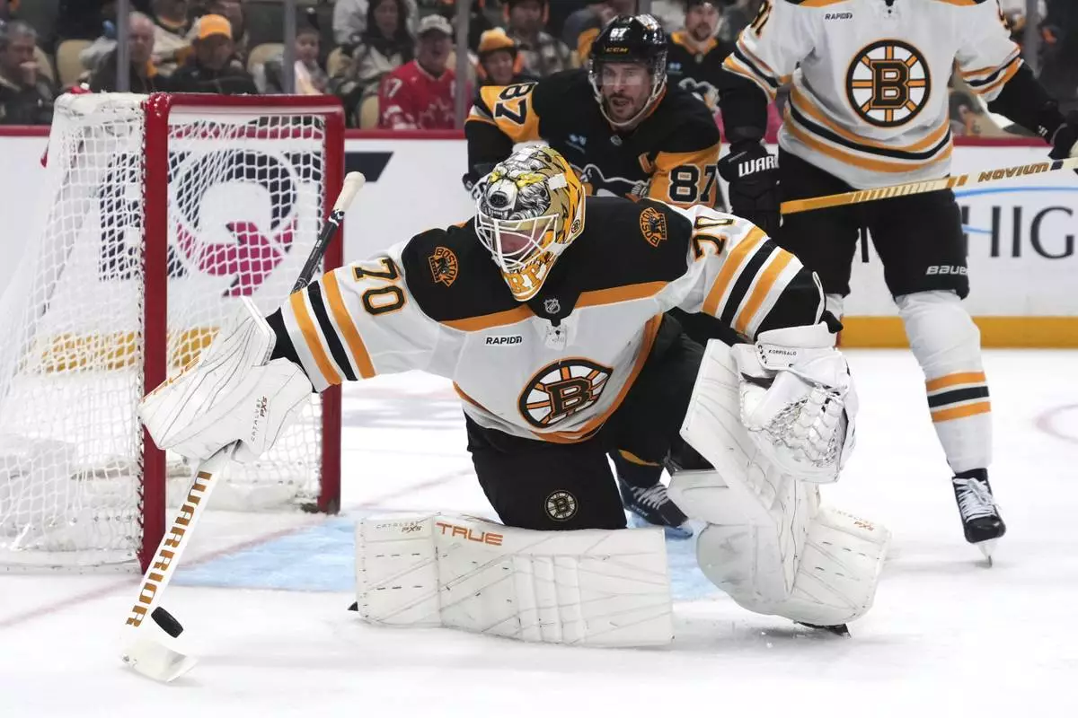 Boston Bruins goaltender Joonas Korpisalo (70) tries to control a rebound during the second period of an NHL hockey game against the Pittsburgh Penguins in Pittsburgh, Sunday, April 13, 2025. (AP Photo/Gene J. Puskar)