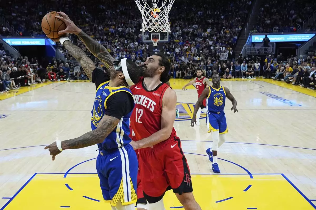 Houston Rockets center Steven Adams (12) blocks a shot by Golden State Warriors guard Gary Payton II (0) during the second half of an NBA basketball game Sunday, April 6, 2025, in San Francisco. (AP Photo/Godofredo A. Vásquez)