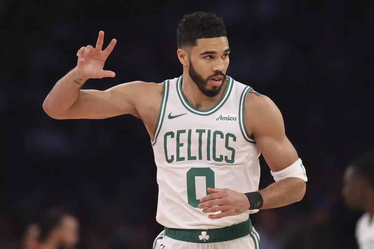 Boston Celtics' Jayson Tatum reacts after scoring a three point basket during the first half of an NBA basketball game against the New York Knicks, Tuesday, April 8, 2025, in New York. (AP Photo/Pamela Smith)