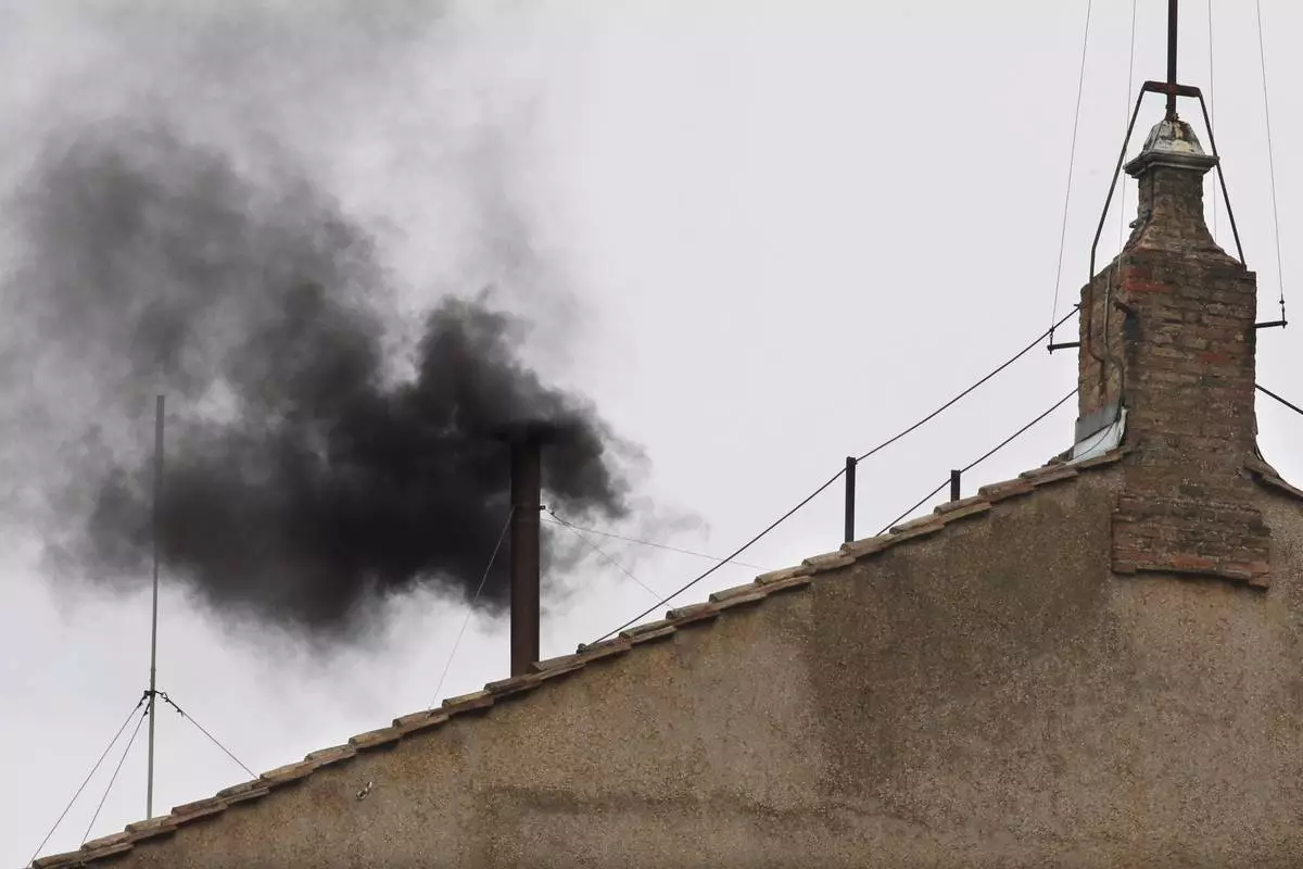 FILE - Black smoke emerges from the chimney on the Sistine Chapel as cardinals voted on the second day of the conclave to elect a pope in St. Peter's Square at the Vatican, Wednesday, March 13, 2013. (AP Photo/Michael Sohn, File)