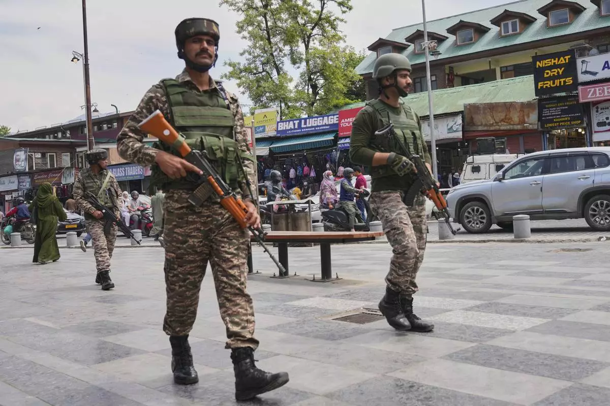 Indian paramilitary soldiers patrol a busy market in Srinagar, Indian controlled Kashmir, Thursday, April 24, 2025. (AP Photo/Dar Yasin)