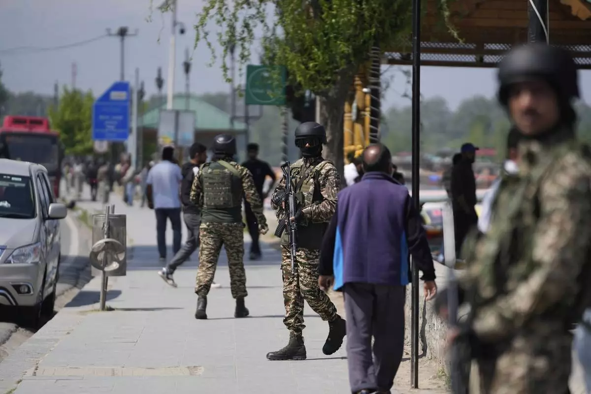 Indian soldiers guard on the banks of Dal Lake in Srinagar, Indian controlled Kashmir, Thursday, April 24, 2025. (AP Photo/Mukhtar Khan)