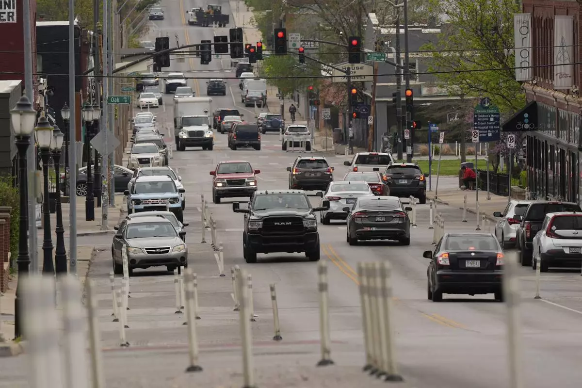 Motorists navigate 31st Street in Kansas City, Mo., where the city implemented a "road diet" reducing the street from four lanes to two in an effort to reduce speeding and accidents, Thursday, April 17, 2025. (AP Photo/Charlie Riedel)
