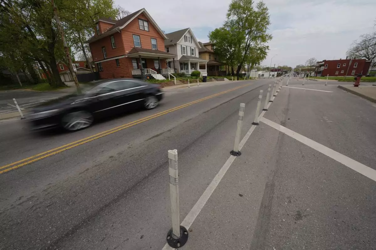 A motorist drives on 31st Street in Kansas City, Mo., where the city implemented a "road diet" reducing the street from four lanes to two in an effort to reduce speeding and accidents, Thursday, April 17, 2025. (AP Photo/Charlie Riedel)