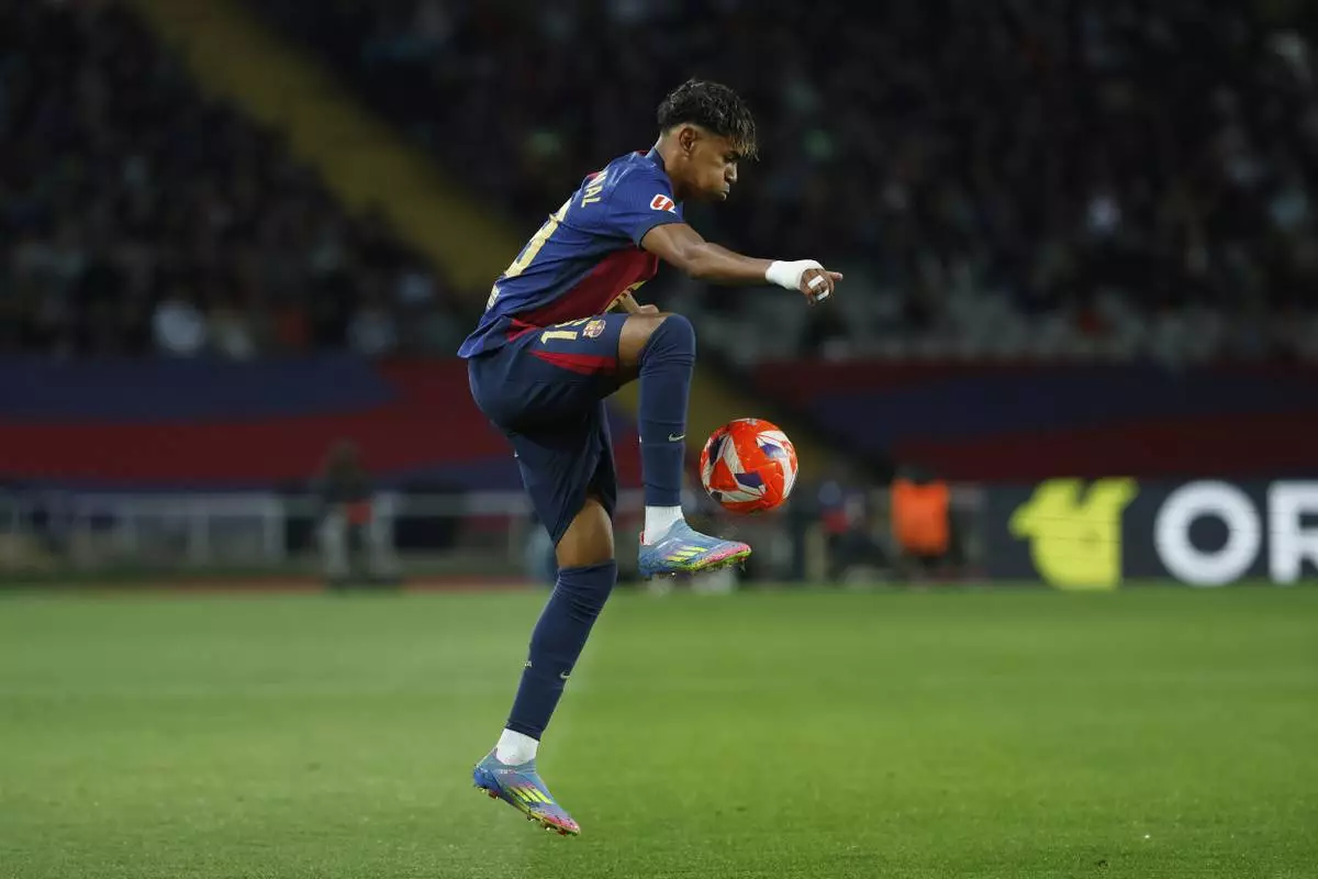 Barcelona's Lamine Yamal controls the ball during a Spanish La Liga soccer match between Barcelona and Mallorca at the Lluis Companys Olympic stadium in Barcelona, Spain, Tuesday, April 22, 2025. (AP Photo/Joan Monfort)