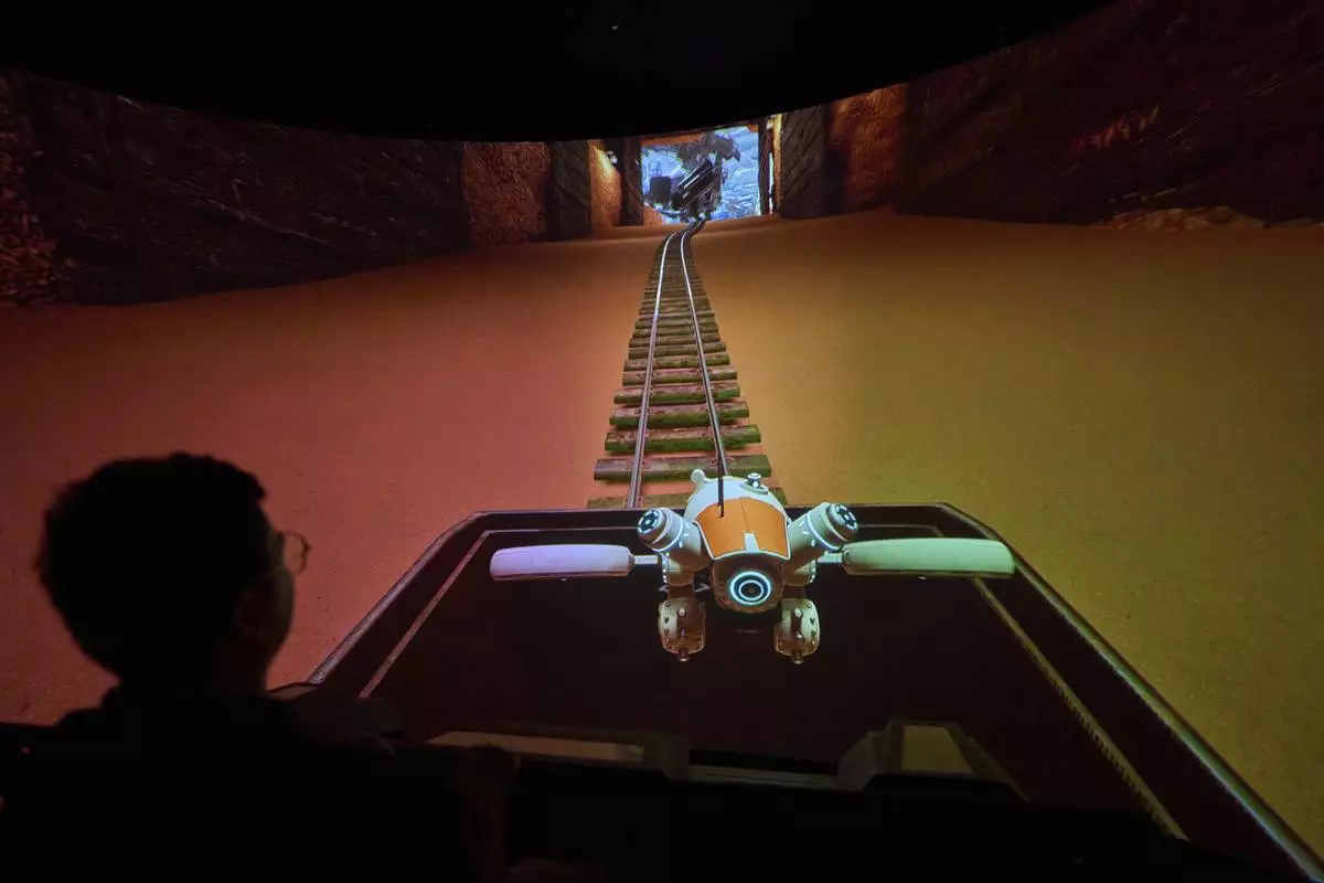 A man experience a 3D ride at the experience center of Zhuoyuan Tech Co., Ltd in Panyu district of Guangzhou city in southern China's Guangdong province on Wednesday, April 16, 2025. (AP Photo/Ng Han Guan)