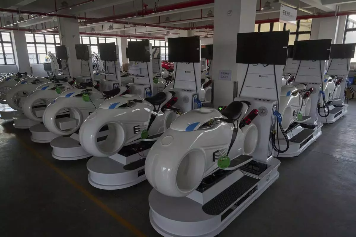 Completed virtual reality gaming platforms are covered up at the factory of Zhuoyuan Tech Co., Ltd in Panyu district of Guangzhou city in southern China's Guangdong province on Wednesday, April 16, 2025. (AP Photo/Ng Han Guan)