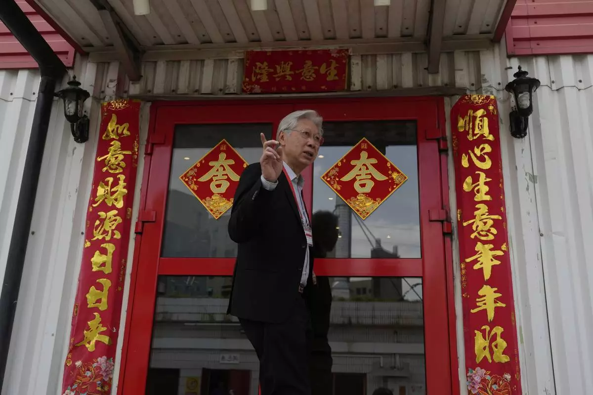 Danny Lau, Managing Director of Kam Pin Industrial (HK) Ltd, stands at the entrance to the office in Dongguan city in southern China's Guangdong province on Thursday, April 17, 2025. (AP Photo/Ng Han Guan)
