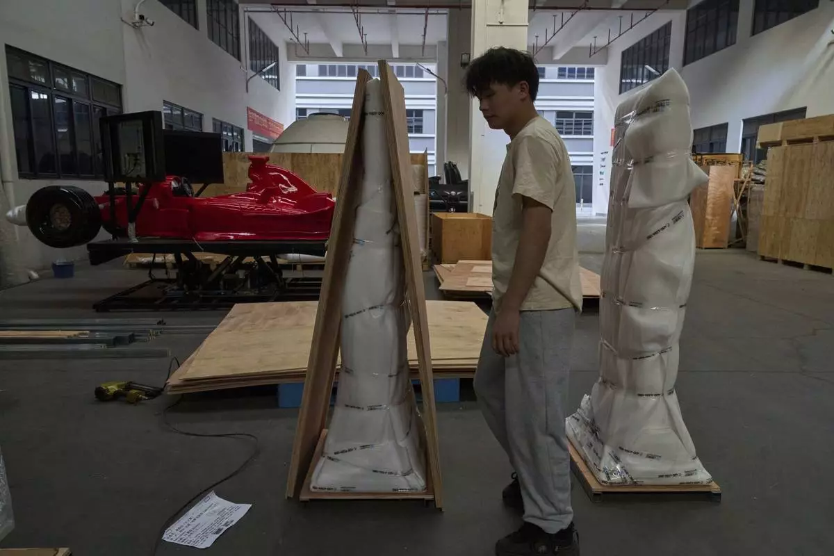 A worker prepares products for shipping at the factory of Zhuoyuan Tech Co., Ltd in Panyu district of Guangzhou city in southern China's Guangdong province on Wednesday, April 16, 2025. (AP Photo/Ng Han Guan)