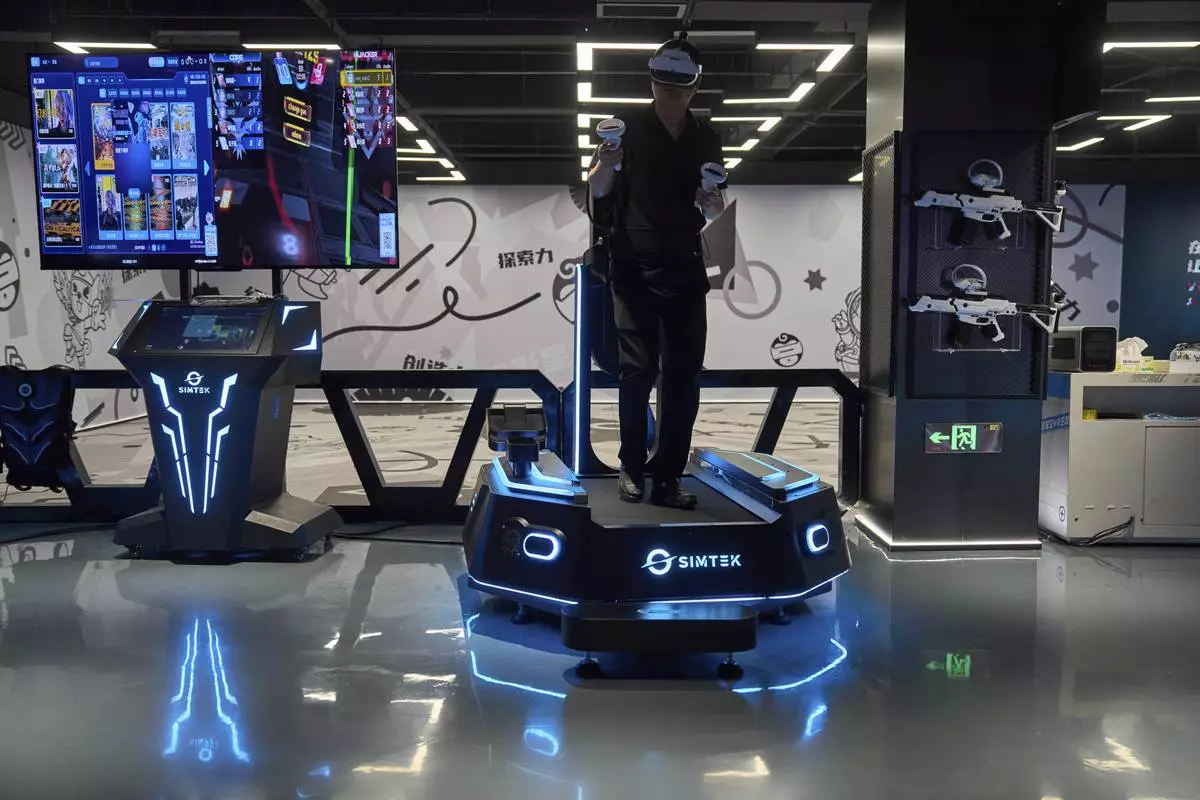 A man tries out a virtual reality platform at the experience center of Zhuoyuan Tech Co., Ltd in Panyu district of Guangzhou city in southern China's Guangdong province on Wednesday, April 16, 2025. (AP Photo/Ng Han Guan)