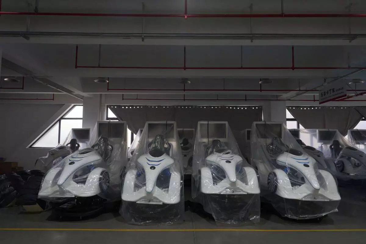 Completed virtual reality gaming platforms are covered up at the factory of Zhuoyuan Tech Co., Ltd in Panyu district of Guangzhou city in southern China's Guangdong province on Wednesday, April 16, 2025. (AP Photo/Ng Han Guan)