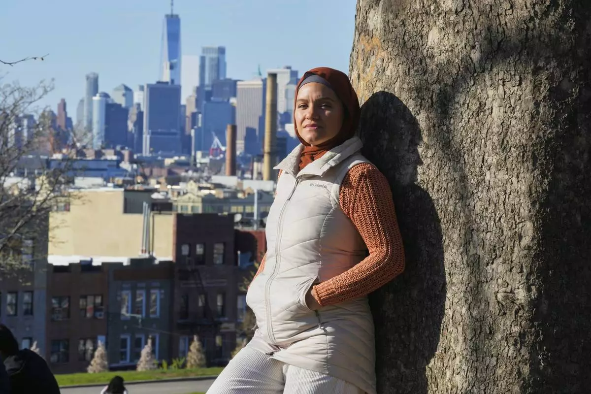 Daniris Espinal stands for a portrait in Sunset Park, in the Brooklyn borough of New York, Thursday, April 17, 2025. (AP Photo/Richard Drew)