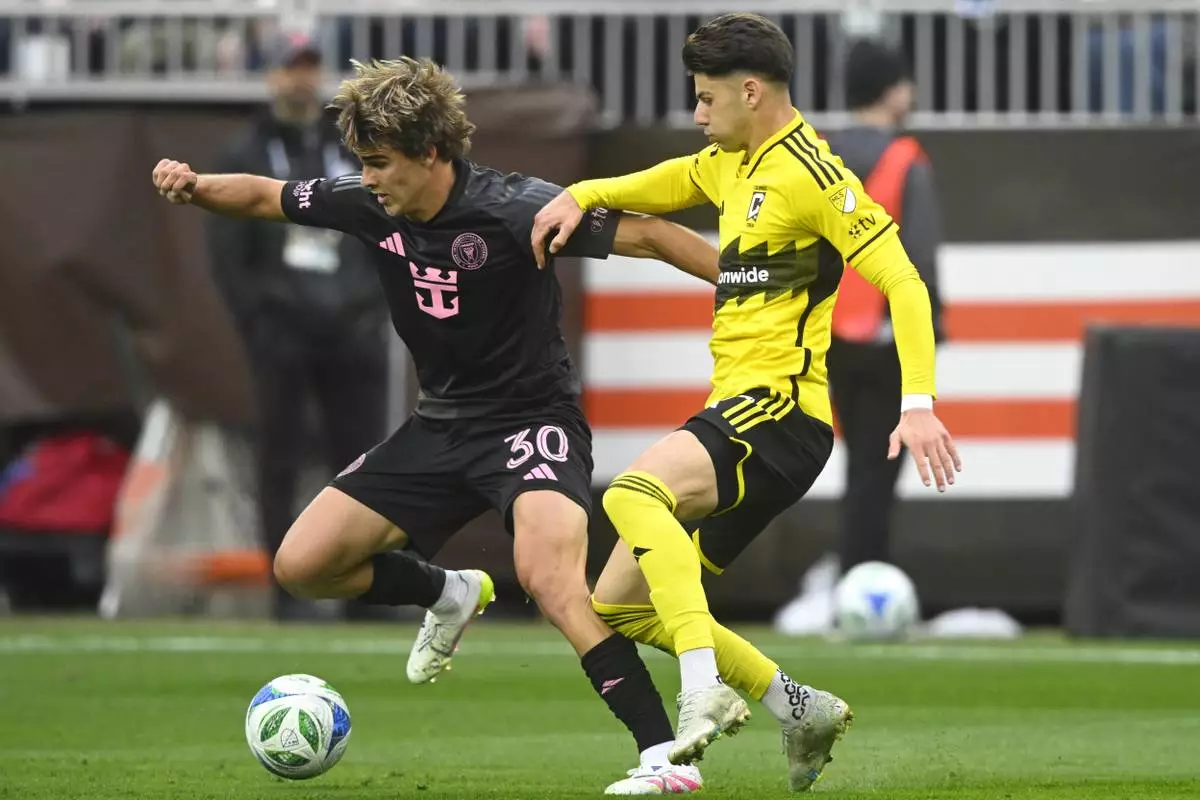 Inter Miami midfielder Benjamin Cremaschi (30) controls the ball beside Columbus Crew forward Max Arftsen, right, during the first half of an MLS soccer match Saturday, April 19, 2025, in Cleveland, Ohio. (AP Photo/David Richard)