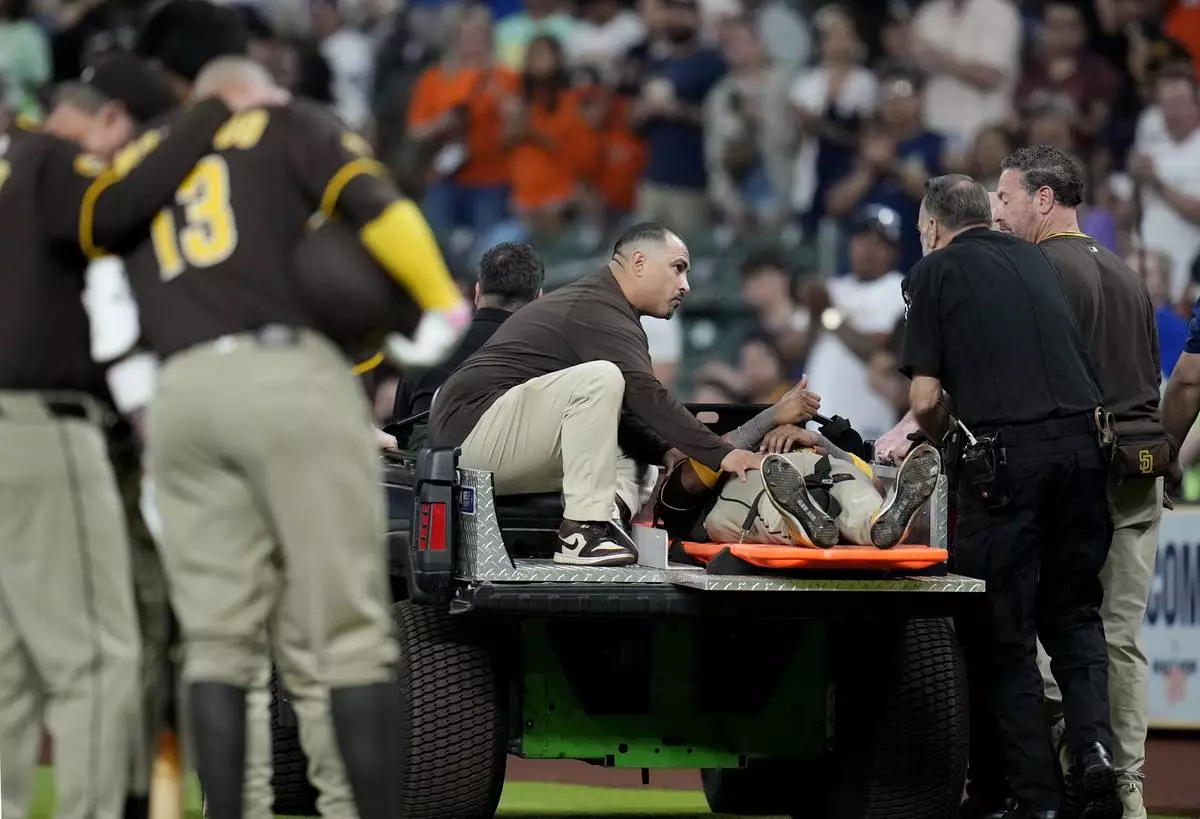 San Diego Padres' Luis Arraez gives a thumbs up as he was carted off the field after a collision with Houston Astros second baseman Mauricio Dubon during the first inning of a baseball game Sunday, April 20, 2025, in Houston. (AP Photo/Karen Warren)