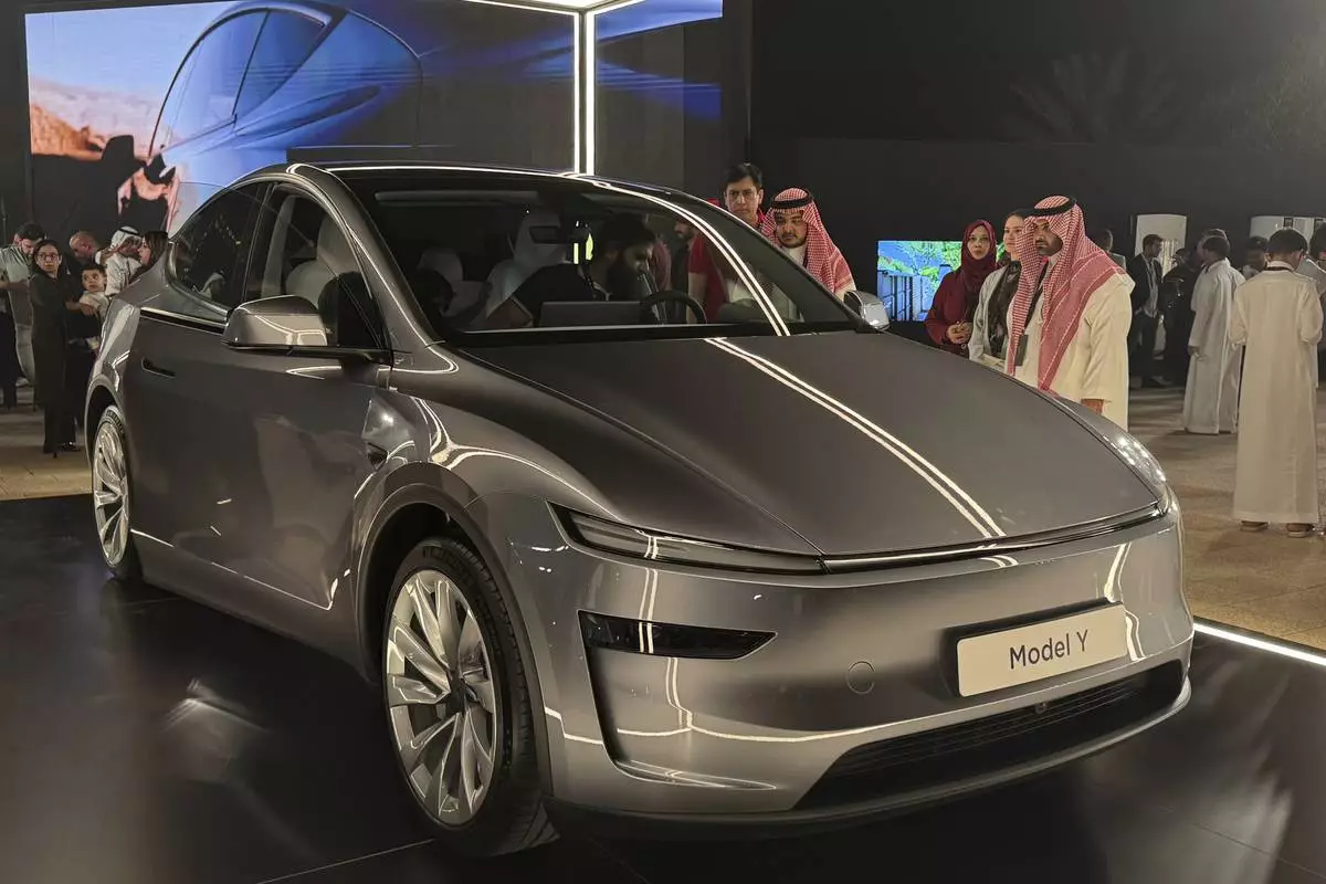 People attend a celebration for the start of Tesla operations in Saudi Arabia in historic Diriyah near Riyadh, Saudi Arabia, on Thursday, April 10, 2025 (AP Photo/Baraa Anwer)