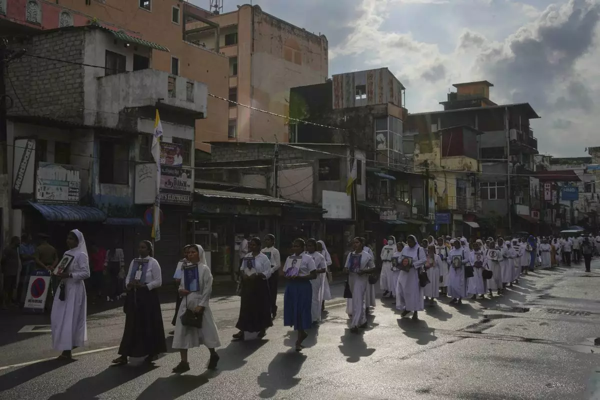 Sri Lankan Catholics nuns carry portraits of the victims of the 2019 Easter Sunday attacks during its sixth anniversary commemoration in Colombo, Sri Lanka, Monday, April 21, 2025. (AP Photo/Eranga Jayawardena)