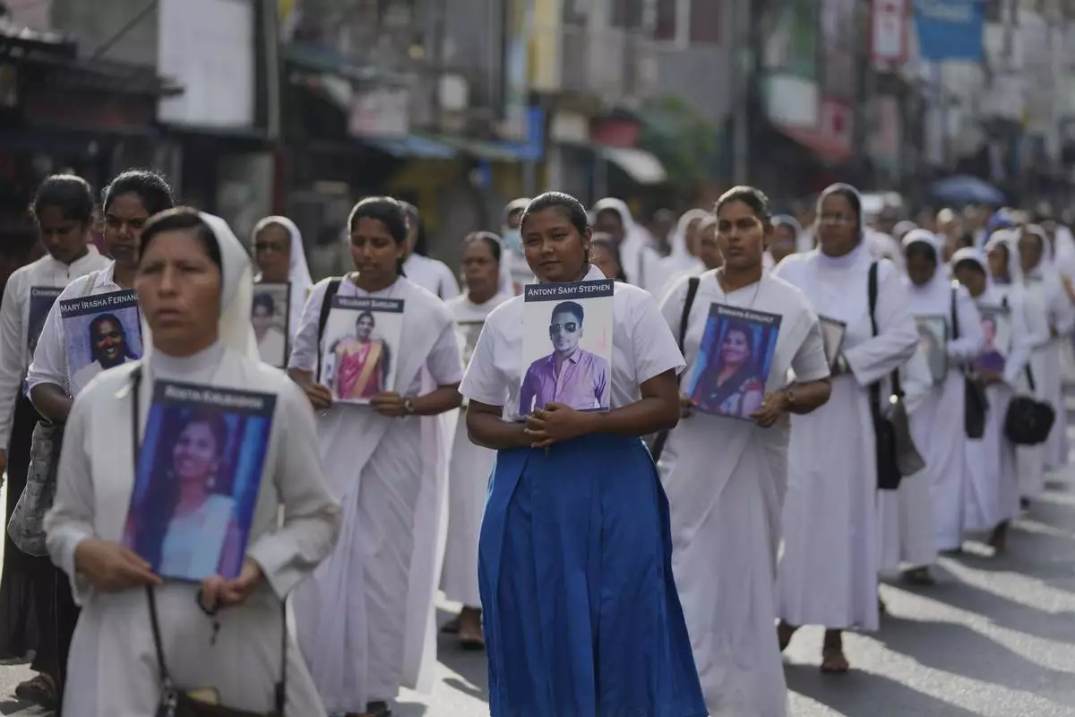 Sri Lankan Catholics nuns carry portraits of the victims of the 2019 Easter Sunday attacks during its sixth anniversary commemoration in Colombo, Sri Lanka, Monday, April 21, 2025. (AP Photo/Eranga Jayawardena)