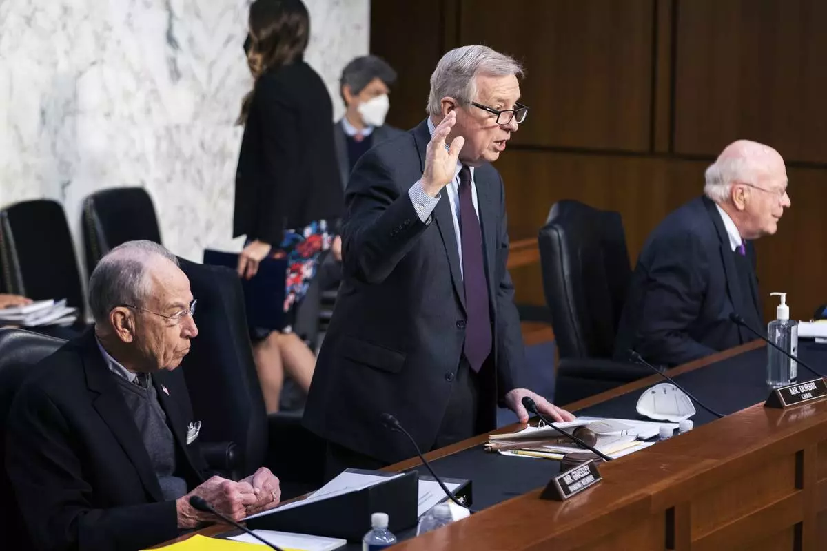 FILE - Senate Judiciary Committee Chairman Sen. Dick Durbin, D-Ill., with ranking member Sen. Chuck Grassley, R-Iowa, left, and Sen. Patrick Leahy, D-Vt., right, swears in Assistant Attorney General for National Security Division Matthew Olsen and Executive Assistant Director, National Security Branch of the FBI Jill Sanborn during the committee hearing to examine the domestic terrorism threat one year after January 6, on Capitol Hill, Feb. 10, 2022, in Washington. (AP Photo/Manuel Balce Ceneta, File)