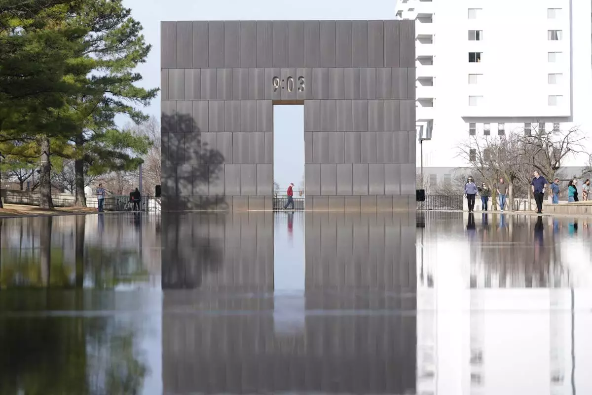 Visitors walk around the Reacting Pond at the Oklahoma City National Memorial & Museum in Oklahoma City on March 12, 2025. (AP Photo/LM Otero)