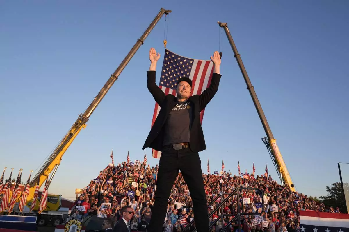 FILE - Tesla and SpaceX CEO Elon Musk walks to the stage to speak at the Butler Farm Show, Oct. 5, 2024, in Butler, Pa. (AP Photo/Alex Brandon, file)