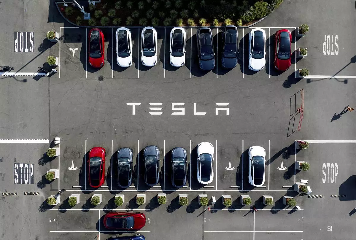 FILE - Tesla vehicles line a parking lot at the company's Fremont, Calif., factory on Sept. 18, 2023. (AP Photo/Noah Berger, file)