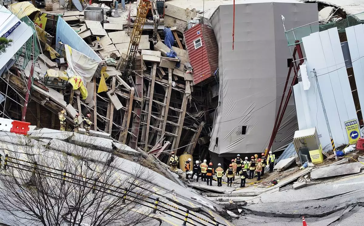 South Korean firefighters work the scene of a collapsed subway construction site in Gwangmyeong, South Korea, Saturday, April 12, 2025. (Hong Ki-won/Yonhap via AP)