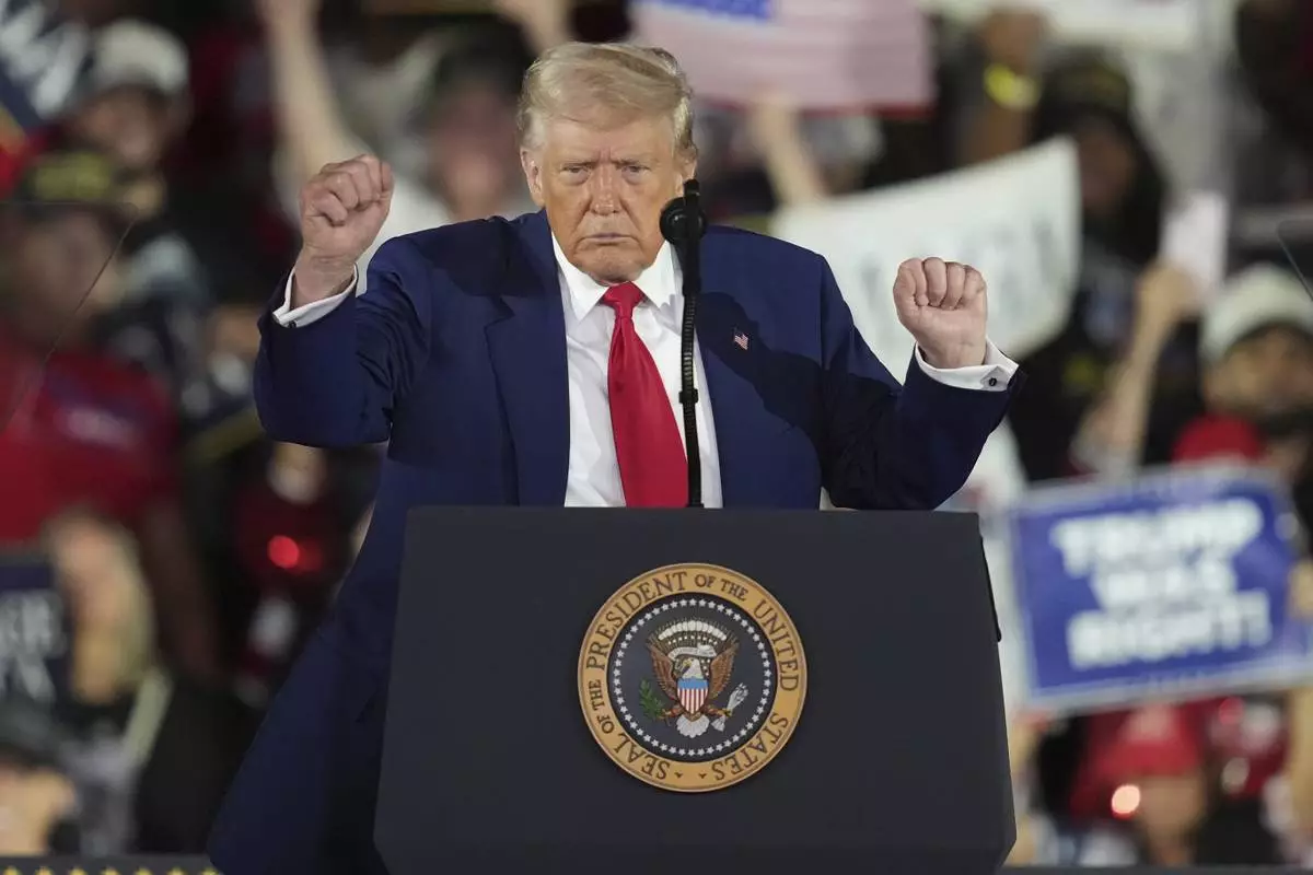President Donald Trump dances after speaking at Macomb Community College, Tuesday, April 29, 2025, in Warren Mich. (AP Photo/Paul Sancya)