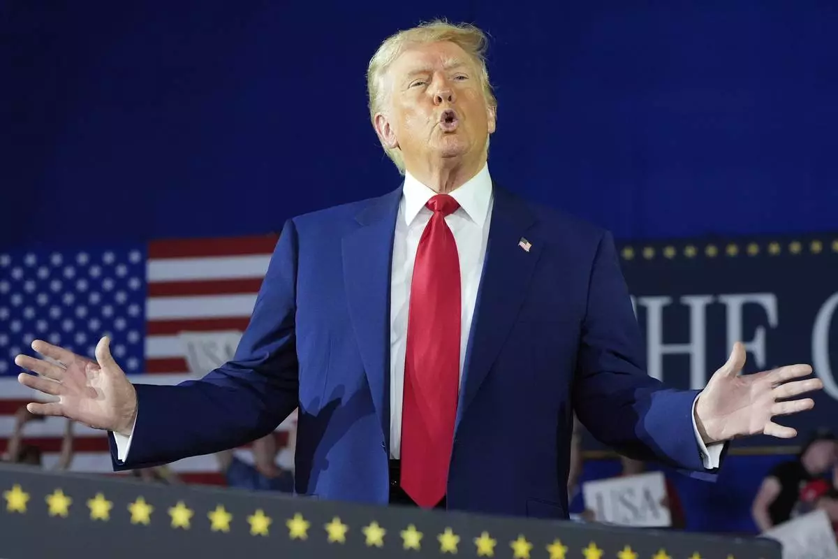 President Donald Trump arrives to speak on his first 100 days at Macomb County Community College Sports Expo Center, Tuesday, April 29, 2025, in Warren, Mich. (AP Photo/Alex Brandon)