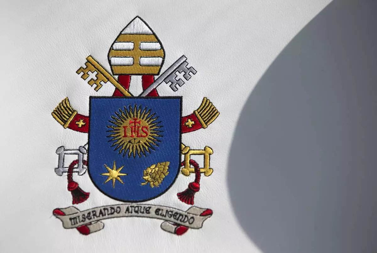 FILE - Pope Francis's coat of arms adorns the seat of a popemobile that will be used during his upcoming visit to Mexico, inside the presidential hangar at Mexico City's airport, Monday, Feb. 8, 2016. (AP Photo/Rebecca Blackwell, file)