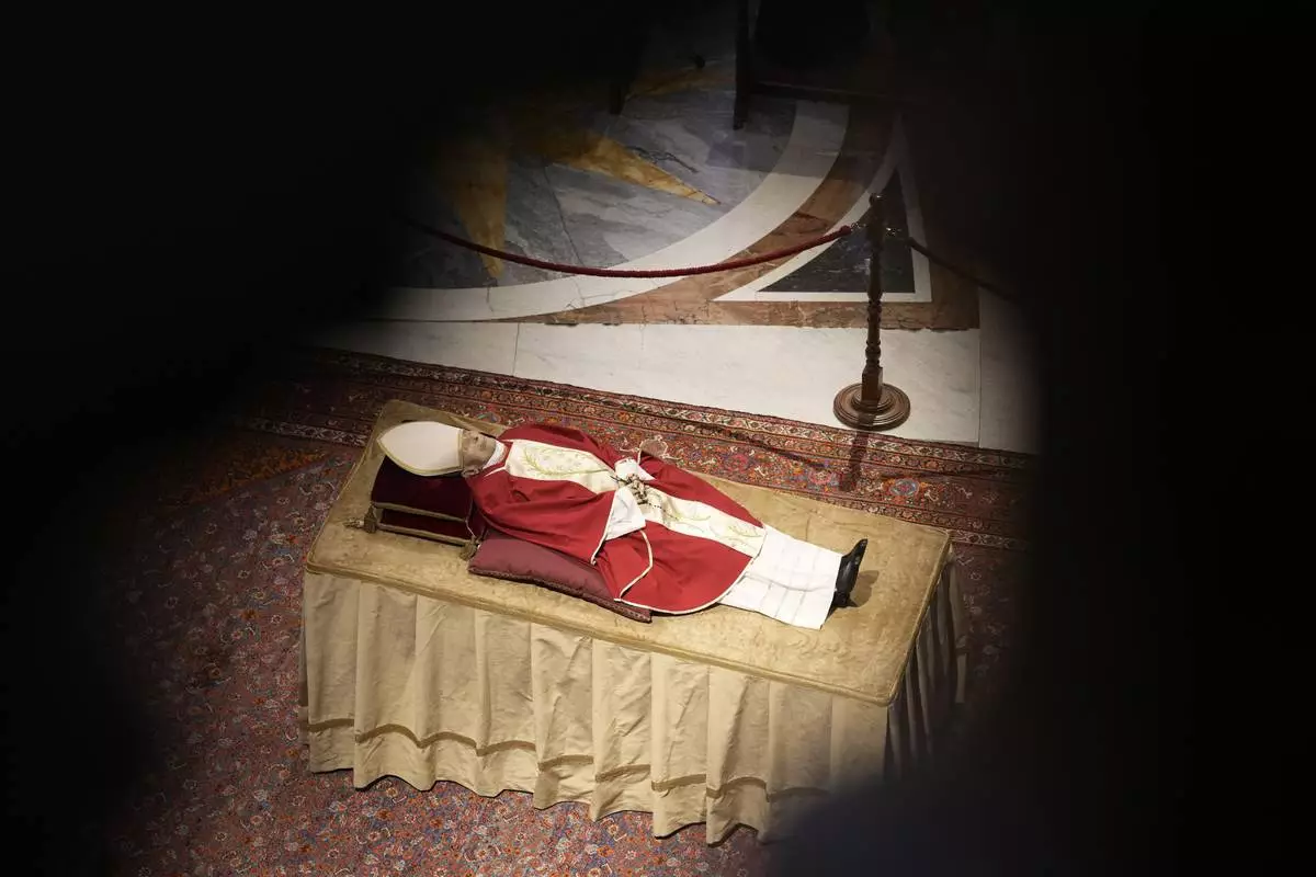 FILE - The body of late Pope Emeritus Benedict XVI lies out in state inside St. Peter's Basilica at The Vatican, Tuesday, Jan. 3, 2023. (AP Photo/Andrew Medichini, file)