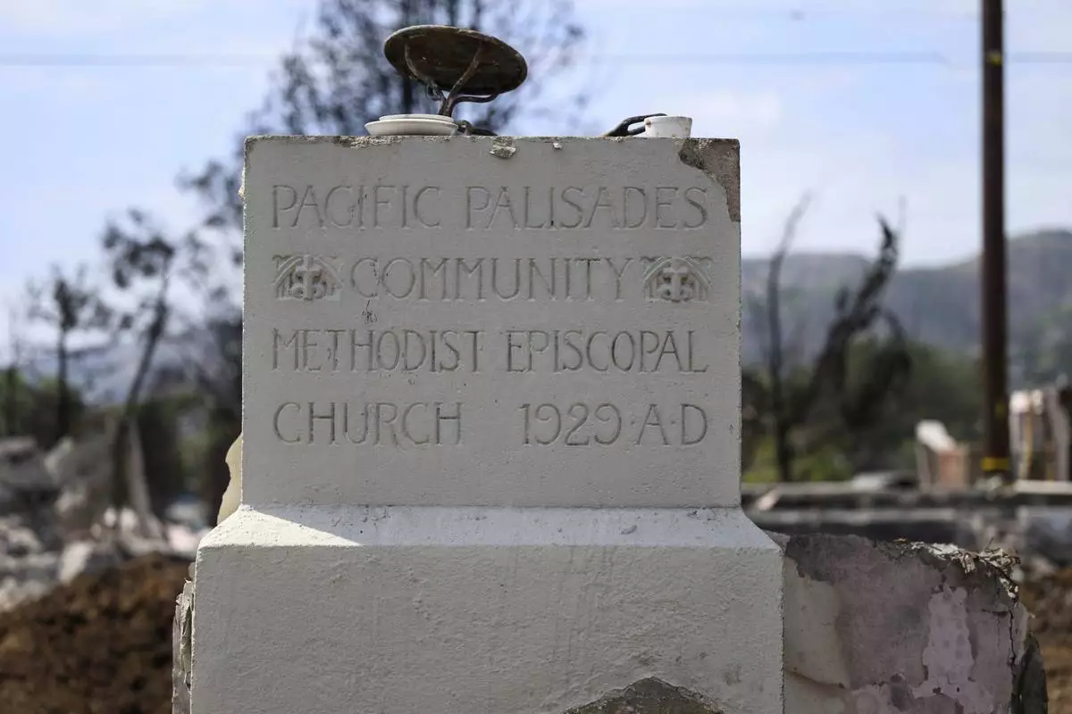 The remains of the cornerstone of the Community United Methodist Church of the Pacific Palisades are shown, Friday, April 18, 2025, in the Pacific Palisades area of Los Angeles. (AP Photo/William Liang)