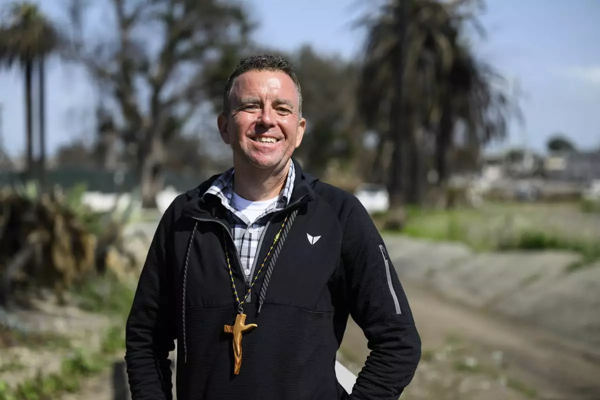Pastor John Shaver poses for a portrait during a Cross Walk event by the Community United Methodist Church of the Pacific Palisades, Friday, April 18, 2025, in the Pacific Palisades area of Los Angeles. (AP Photo/William Liang)
