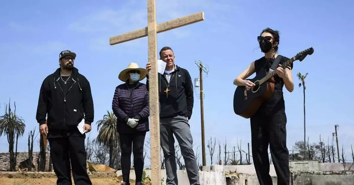 Members of burned LA church bear a cross through their devastated neighborhood to mark Good Friday