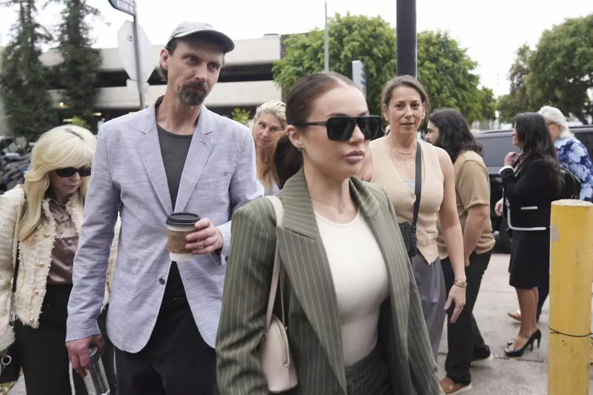 Family members and supporters of Erik and Lyle Menendez arrive in court for a hearing in their case Thursday, April 17, 2025, in Los Angeles. (AP Photo/Damian Dovarganes)