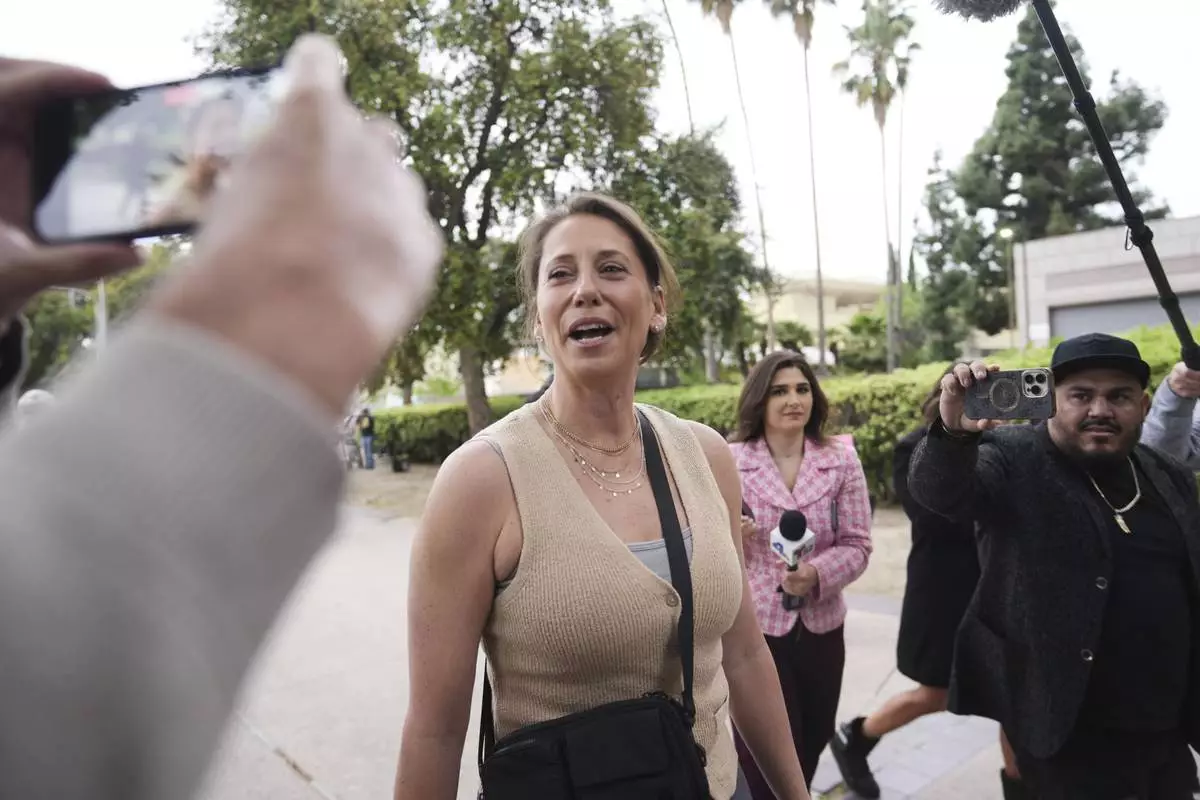 Anamaria Baralt, center, and other family members of Erik and Lyle Menendez arrive in court for a hearing in their case Thursday, April 17, 2025, in Los Angeles. (AP Photo/Damian Dovarganes)