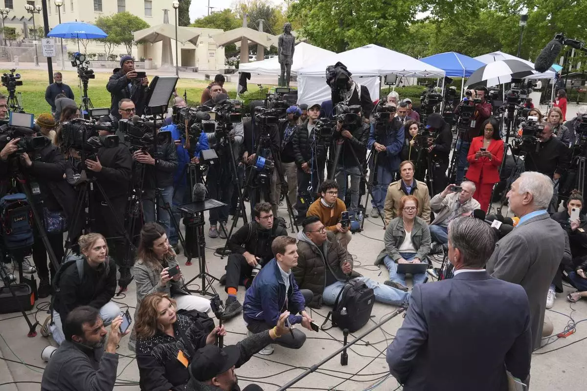 Attorney Mark Geragos, right, representing Erik and Lyle Menendez, who were sentenced in 1996 to life in prison without the possibility of parole for fatally shooting their parents, speaks to the media outside of court after a resentencing hearing in their case, Thursday, April 17, 2025, in Los Angeles. (AP Photo/Damian Dovarganes)