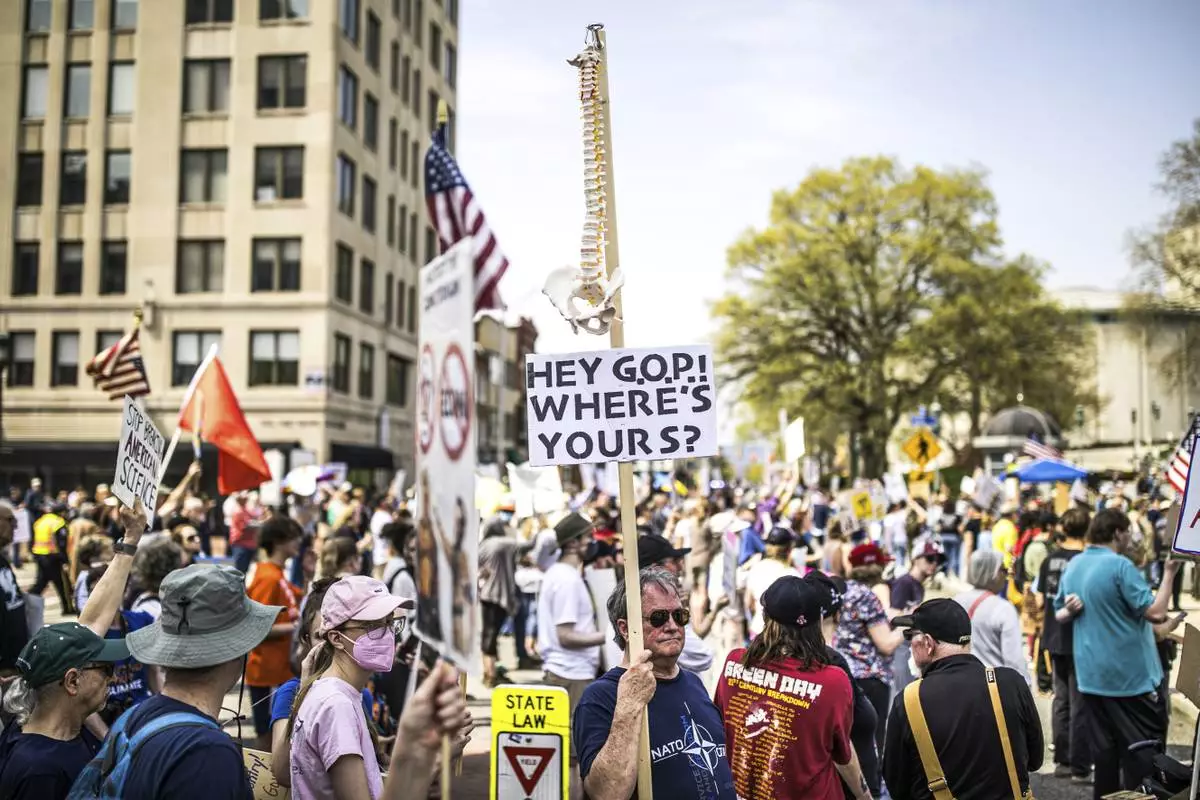Protesters rally at the state capitol in Harrisburg, Pa., during the Day of Action protest against the Trump Administration. Saturday, April 19, 2025. (Zach Gleiter/The Patriot-News via AP)
