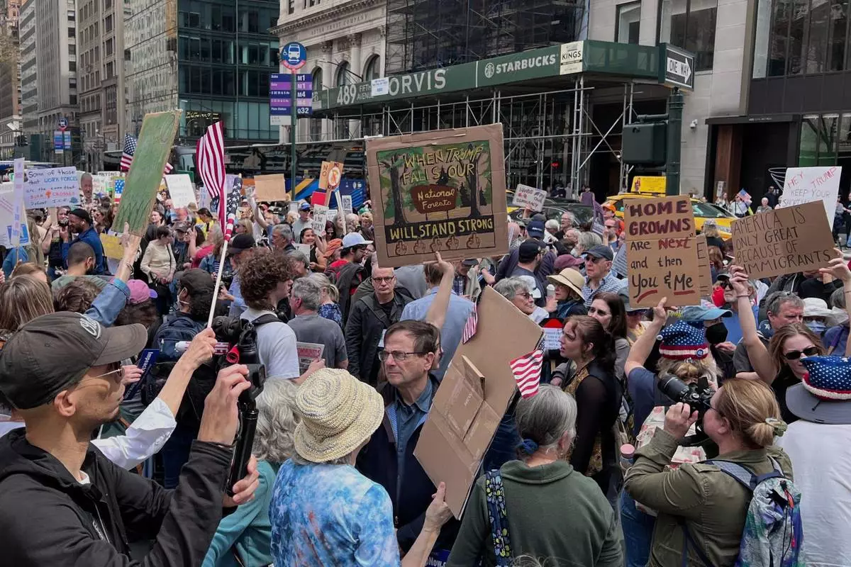 People gather to protest President Donald Trump's policies on Saturday, April 19, 2025 in New York. (AP Photo/Joseph Frederick)