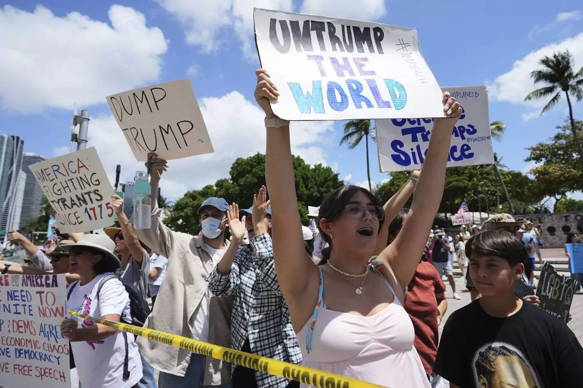Amelie Gayoso chants slogans during a protest against the Trump administration, Saturday, April 19, 2025, in Miami. (AP Photo/Lynne Sladky)