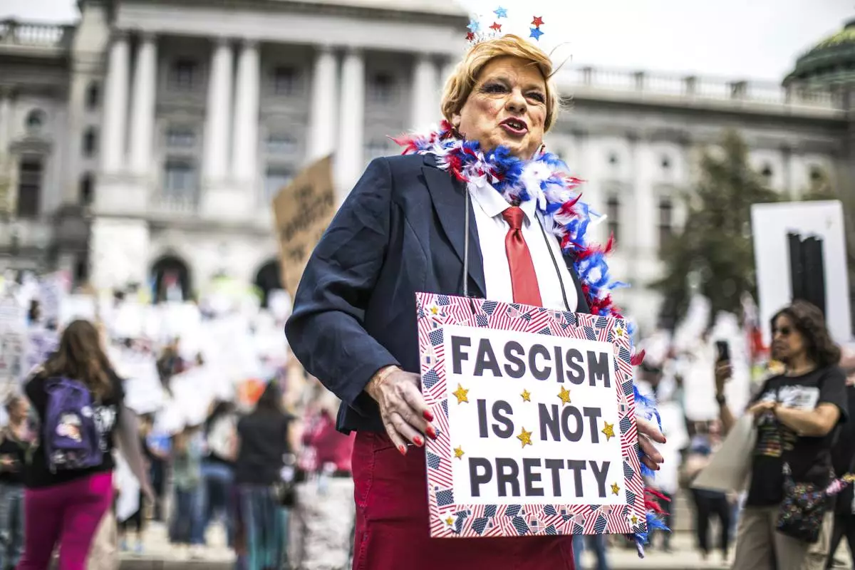 Protesters rally at the state capitol in Harrisburg, Pa., during the Day of Action protest against the Trump Administration. Saturday, April 19, 2025. (Zach Gleiter/The Patriot-News via AP)
