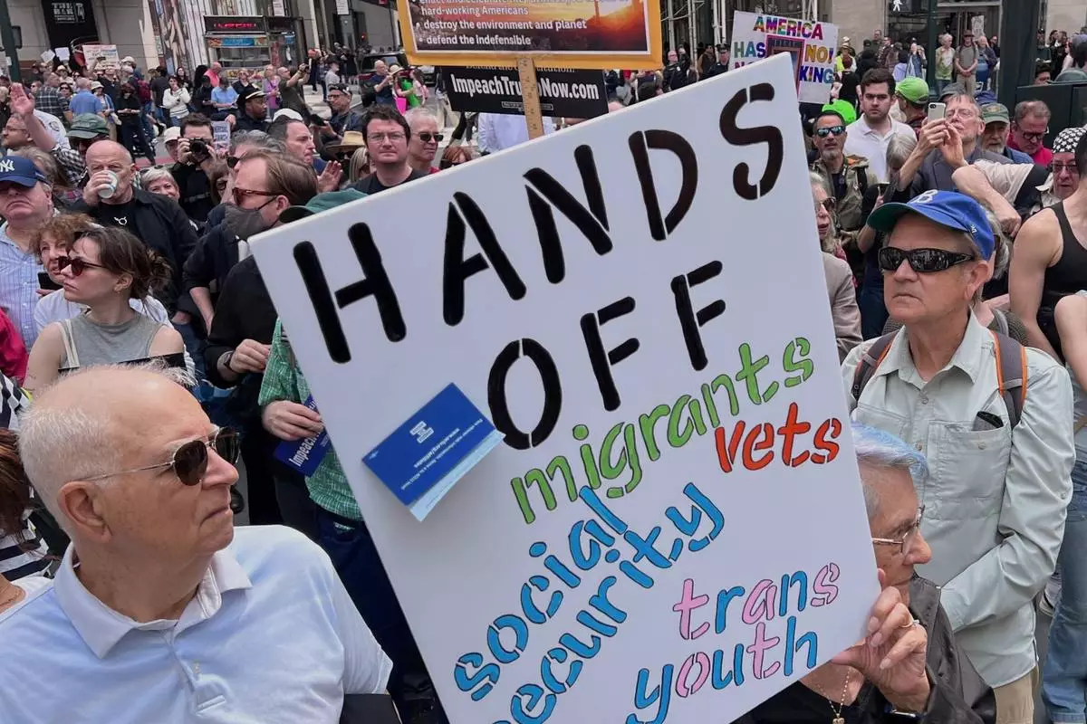 People gather to protest President Donald Trump's policies on Saturday, April 19, 2025 in New York. (AP Photo/Joseph Frederick)